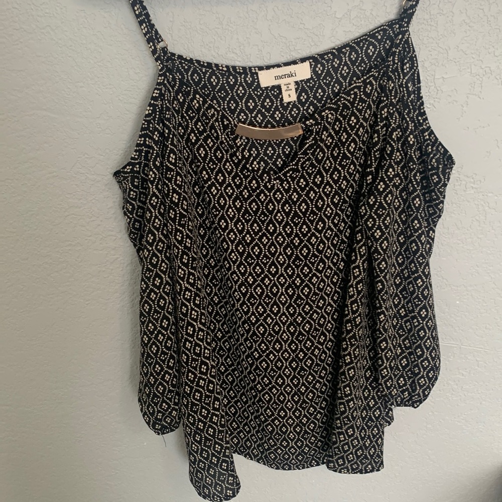 Elegant black and golden blouse with an off the shoulder sleeve.